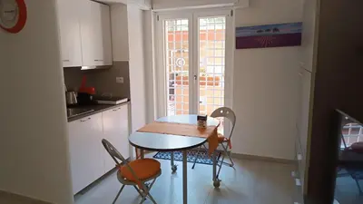 a kitchen with a table and chairs and a window at Vatican tiny house by Gialel in Rome