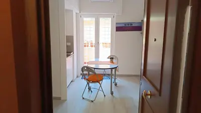 a small table and chairs in a kitchen with a window at Vatican tiny house by Gialel in Rome
