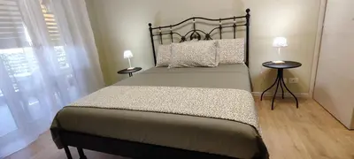 a bedroom with a large bed with two night stands at Charming Apartment 367 in Rome