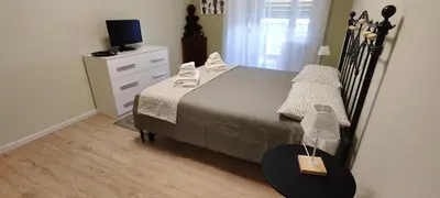 a bedroom with a bed and a dresser with a television at Charming Apartment 367 in Rome