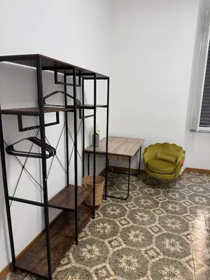 a room with a shelf and a table and a chair at LarisaSuite in Rome