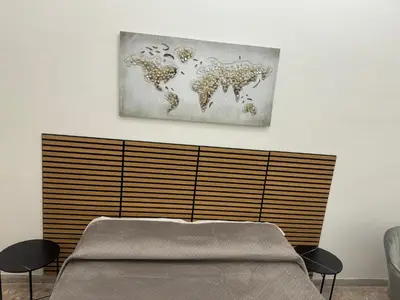 a bedroom with a bed and a painting on the wall at LarisaSuite in Rome