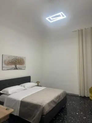a bedroom with a bed with a light on the ceiling at LarisaSuite in Rome
