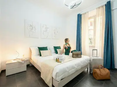 a bedroom with a bed with blue curtains at Dream suite Modern in Rome Air Conditioning WiFi near the Metro A in Rome