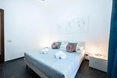 a row of pillows sitting on a bed at Dream suite Modern in Rome Air Conditioning WiFi near the Metro A in Rome