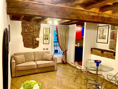 a living room with a couch and a glass table at Pantheon Appartamento Costaguti in Rome