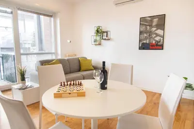 a living room with a white table and chairs at Casetta Pandosia - San Giovanni - Colosseo in Rome