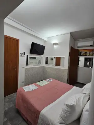 a bedroom with a bed and a flat screen tv at A&F Colosseo in Rome