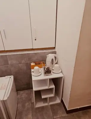 a small bathroom with white cabinets and a sink at A&F Colosseo in Rome