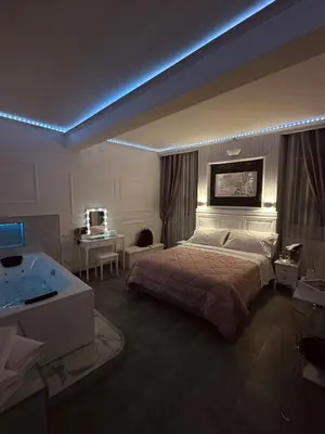 a bedroom with a large bed and a tub in it at A&F Colosseo in Rome