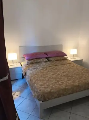 a bedroom with a bed with two lamps on both sides at Notti di San Lorenzo in Rome