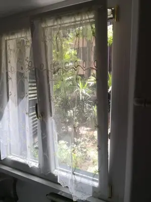 an open window with a view of a garden at Notti di San Lorenzo in Rome