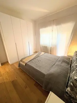 a bedroom with a bed and white cabinets at MilleStorie House Rome in Rome