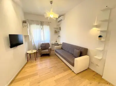 a living room with a couch and a chair at MilleStorie House Rome in Rome