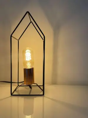 a lamp with a glass box on a table at MilleStorie House Rome in Rome