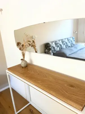 a mirror on a wall above a wooden table at MilleStorie House Rome in Rome