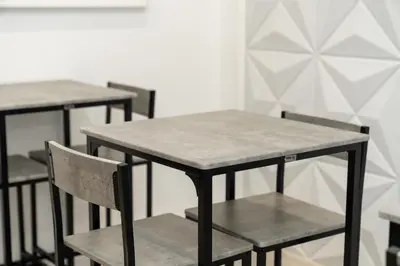 a kitchen with two bar stools and a table at Emm Maison Rome in Rome