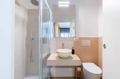 a bathroom with a sink and a shower at Relais Garbatella in Rome