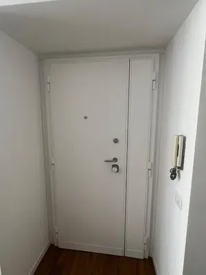 a white door in a room with a wall at Relais Garbatella in Rome