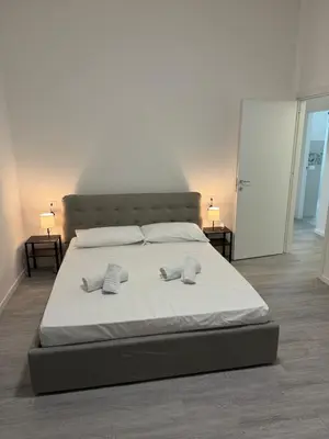 a bedroom with a large bed with two pillows on it at San Paolo Apartment in Rome