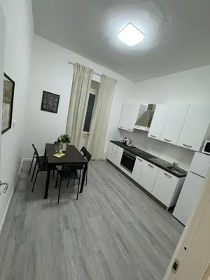 a kitchen and dining room with a table in a room at San Paolo Apartment in Rome