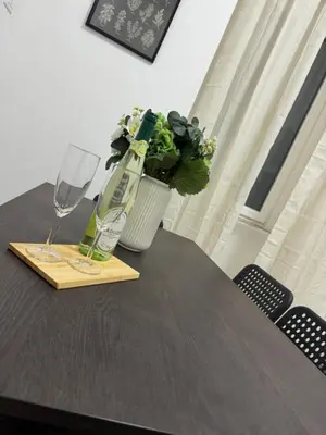 a table with a bottle of wine and a glass at San Paolo Apartment in Rome