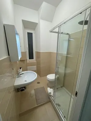 a bathroom with a shower and a sink and a toilet at San Paolo Apartment in Rome
