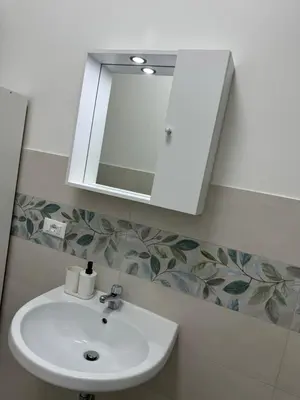 a bathroom with a sink and a mirror at San Paolo Apartment in Rome