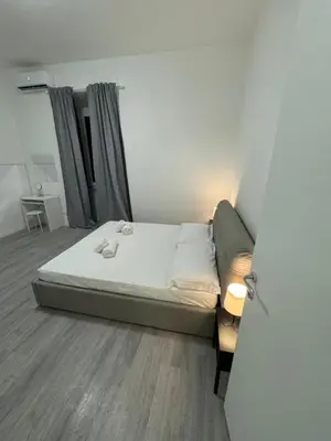 a small bed in a room with a door open at San Paolo Apartment in Rome