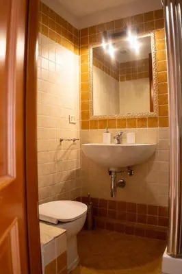 a bathroom with a sink and a toilet and a mirror at Two Bedroom Appartment - 3 min Metro Conca D'Oro by ORPI RENT in Rome