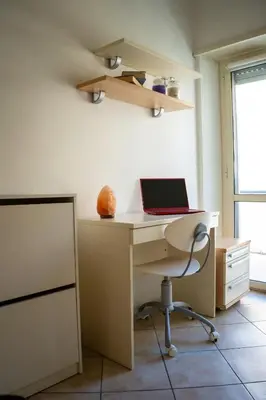 a room with a desk with a laptop on it at Two Bedroom Appartment - 3 min Metro Conca D'Oro by ORPI RENT in Rome
