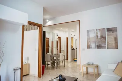 a living room with a couch and a table at Two Bedroom Appartment - 3 min Metro Conca D'Oro by ORPI RENT in Rome