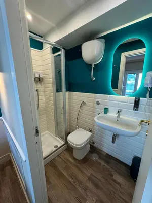 a bathroom with a toilet and a sink and a shower at Le Petit Bijou in Rome