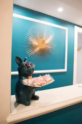 a statue of a bear holding a tray of food at Le Petit Bijou in Rome