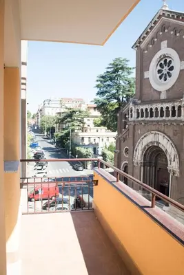 a balcony of a building with a clock tower at Le Petit Bijou in Rome