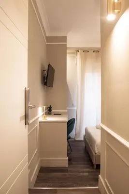a small room with a bed and a desk in it at Le Petit Bijou in Rome