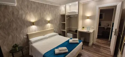 a bedroom with a bed with two towels on it at Le Petit Bijou in Rome