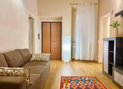 a living room with a couch and a fireplace at DaliTourism - Nazionale Charme in Rome
