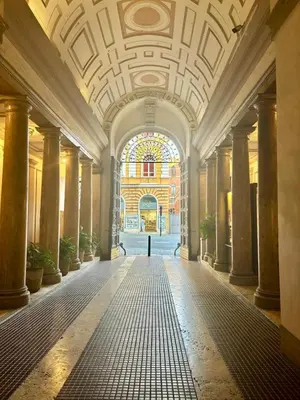 an empty hallway in a building with a stained glass window at DaliTourism - Nazionale Charme in Rome