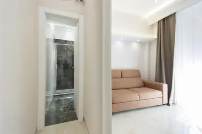 a living room with a couch and a window at Caruso Regal House in Rome