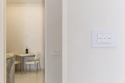 a door leading to a dining room with a table at Caruso Regal House in Rome