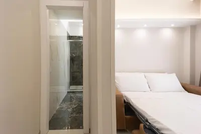 a bedroom with a bed and a glass door at Caruso Regal House in Rome