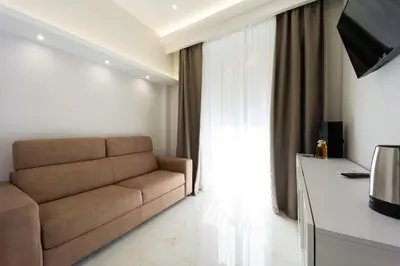 a living room with a couch and a television at Caruso Regal House in Rome