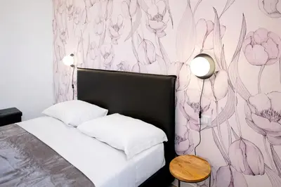 a bedroom with a bed with a flower mural on the wall at Re di Roma Luxury Suite in Rome