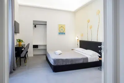 a bedroom with a bed and a desk and a table at Re di Roma Luxury Suite in Rome
