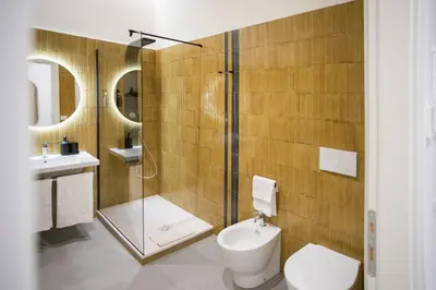 a bathroom with a shower and a toilet and a sink at Re di Roma Luxury Suite in Rome
