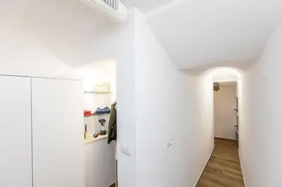 a room with white walls and a white closet at Fabiè Trastevere in Rome