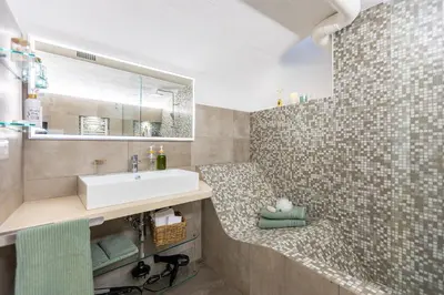 a bathroom with a sink and a mirror at Fabiè Trastevere in Rome