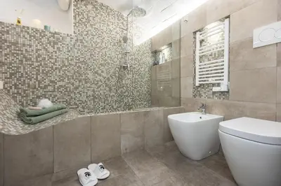 a bathroom with a toilet and a shower and a sink at Fabiè Trastevere in Rome