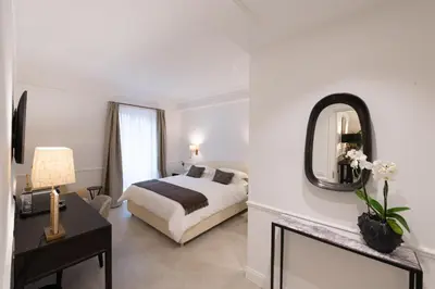a hotel room with a bed and a mirror at La Scalinata - Boutique Guest House in Rome